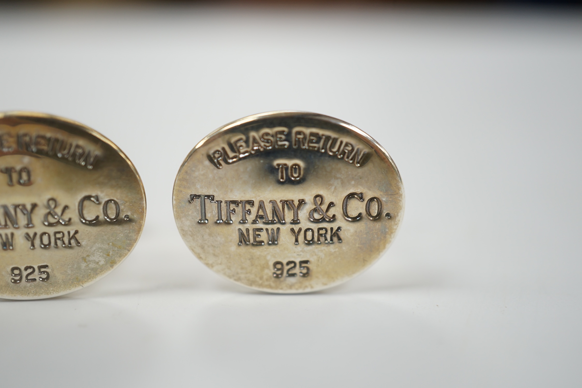 A modern pair of Tiffany & Co gilt 925 oval cufflinks, 19mm, with pouch and box.